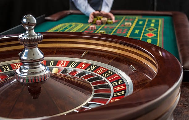 Live dealer studio with multiple camera angles showing blackjack table and roulette wheel at mpo383